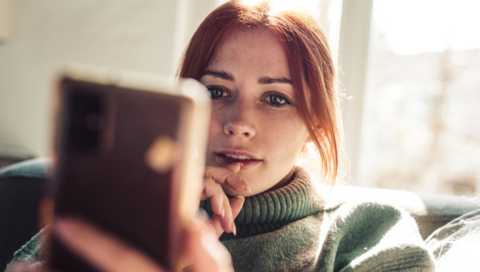 Woman who is reading something on her phone Woman who is reading something on her phone