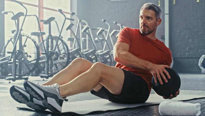 A man doing abdominal exercises with a workout ball A man doing abdominal exercises with a workout ball