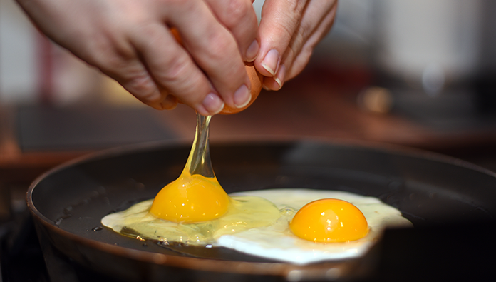 Someone cooking sunny side up eggs Someone cooking sunny side up eggs