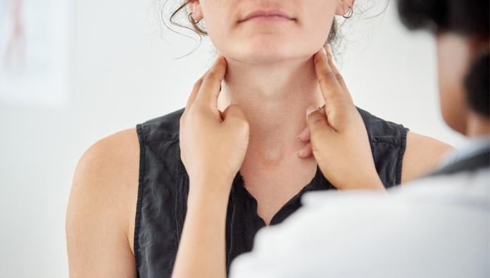 Woman getting her thyroid checked (neck)